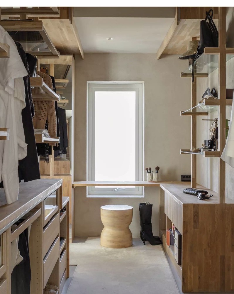 Walk-in closet in light oak with glass shelves and open storage